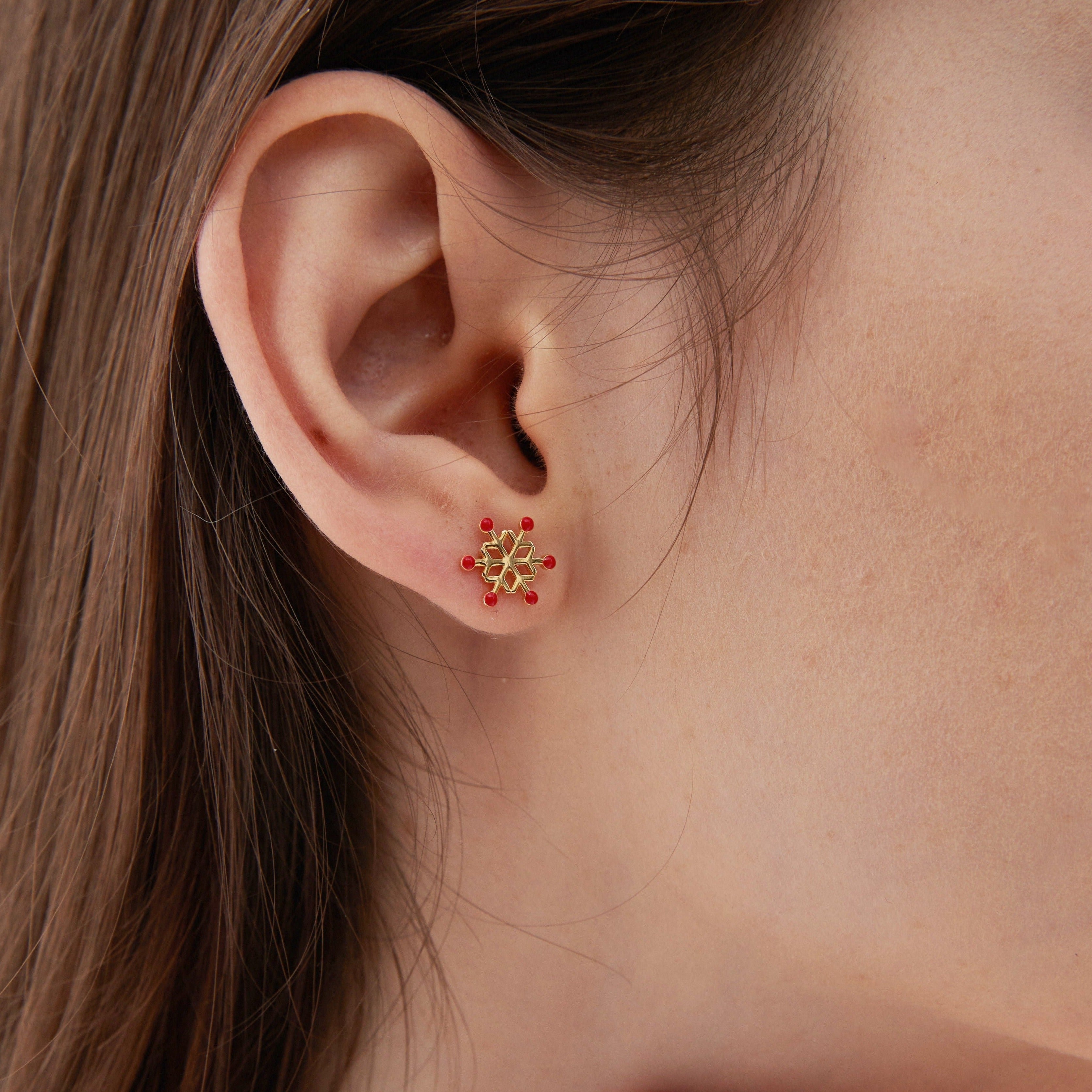 STMG Snowflake and Christmas Tree Stud Earrings in gold on ear