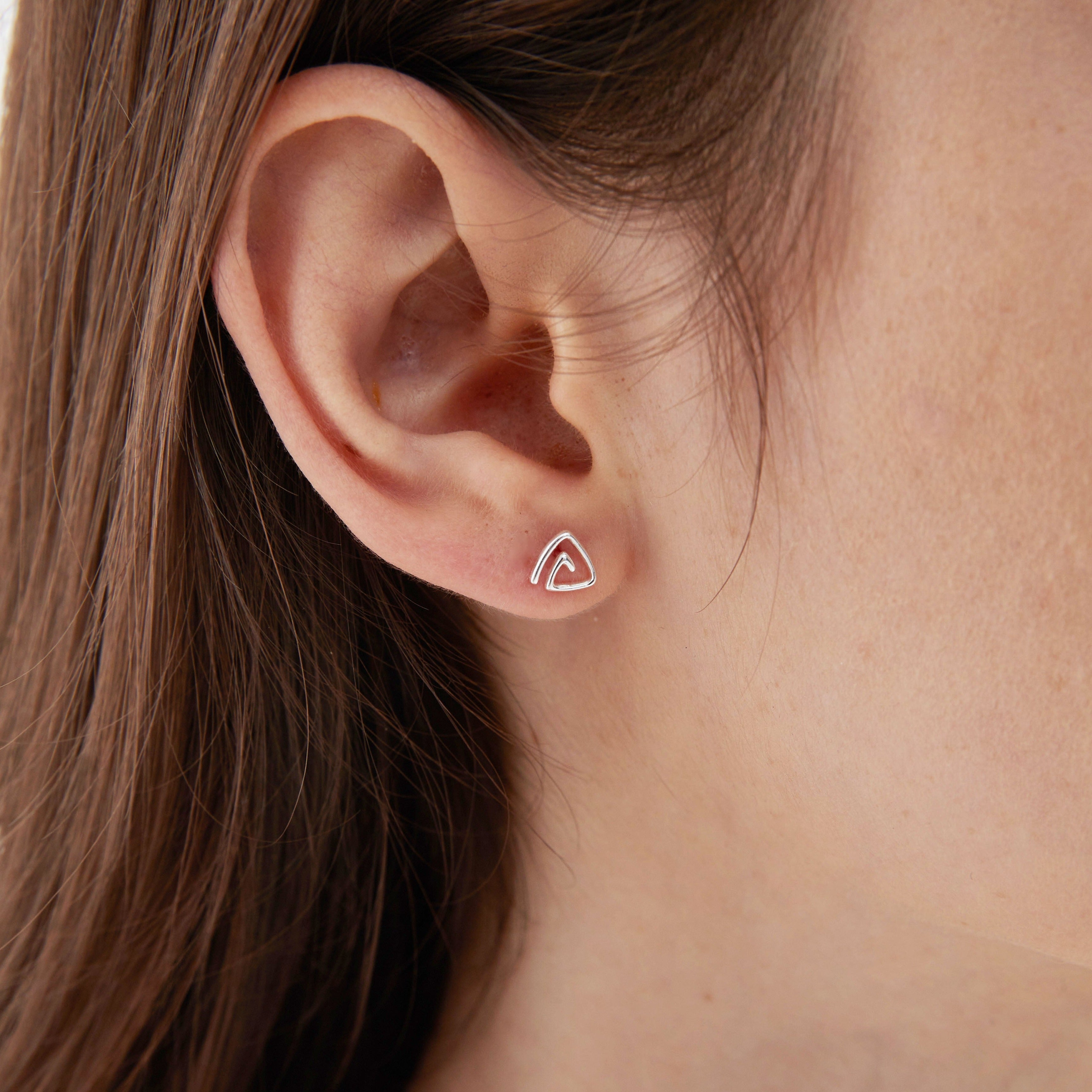 STMG Spiral Triangle Stud Earrings on ear