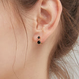 Black CZ Hoops in gold on ear