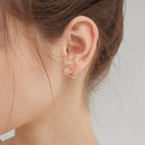 STMG Tiny Crown Hoops in gold on ear