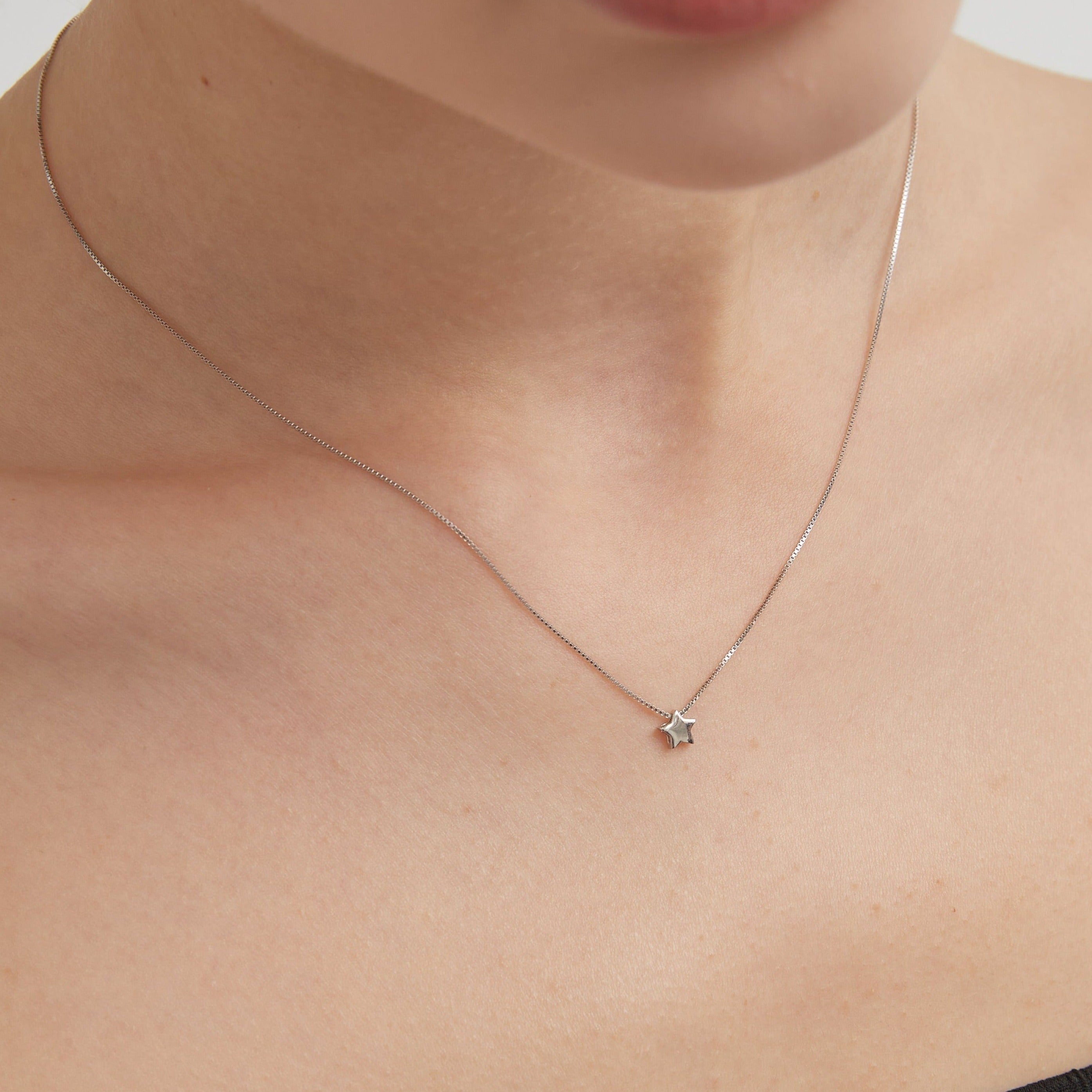 STMG Minimalist Star Necklace on neck