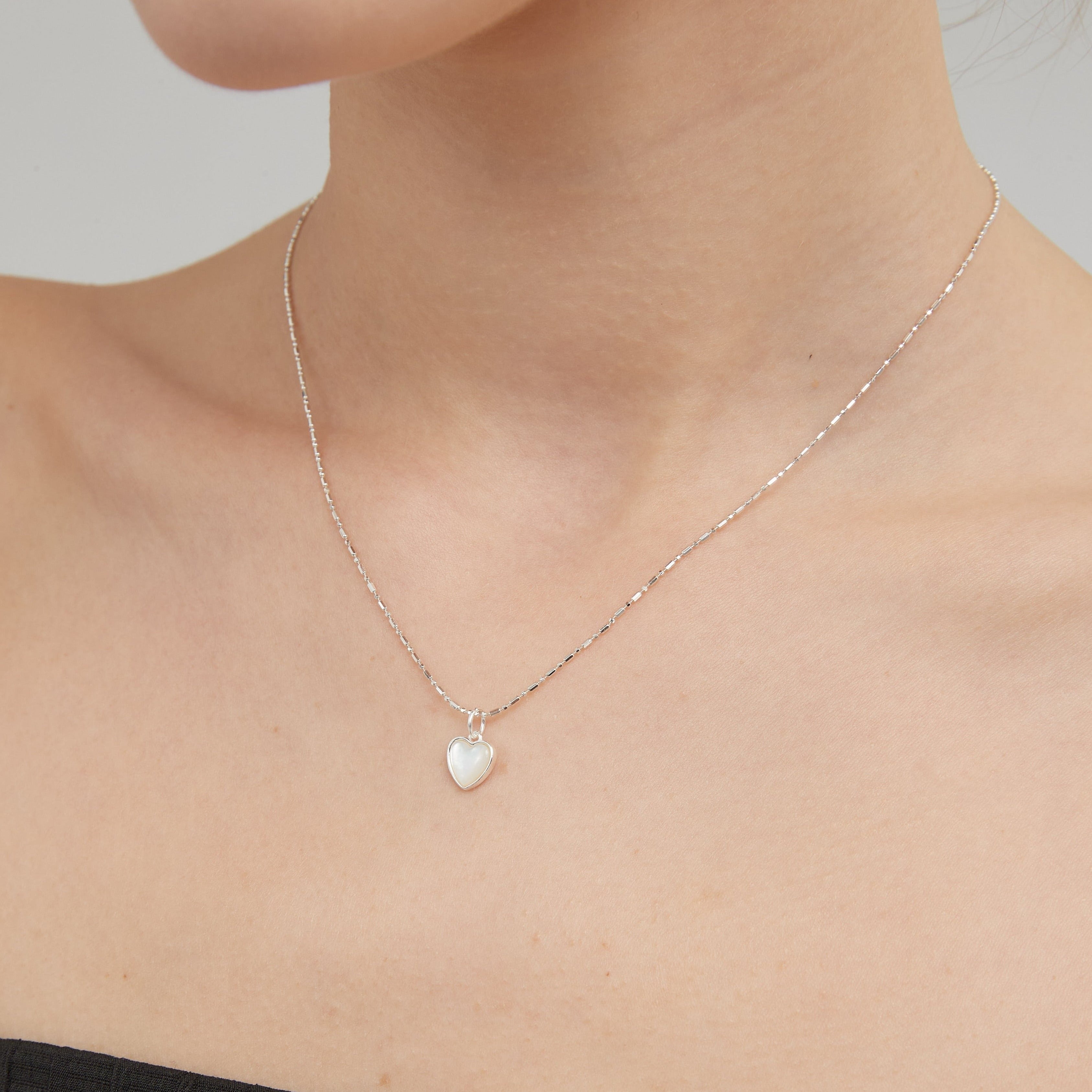 STMG Natural Mother of Pearl Heart Necklace on neck