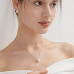 STMG Pearl Adjustable Necklace in silver on neck with matching earrings on ear