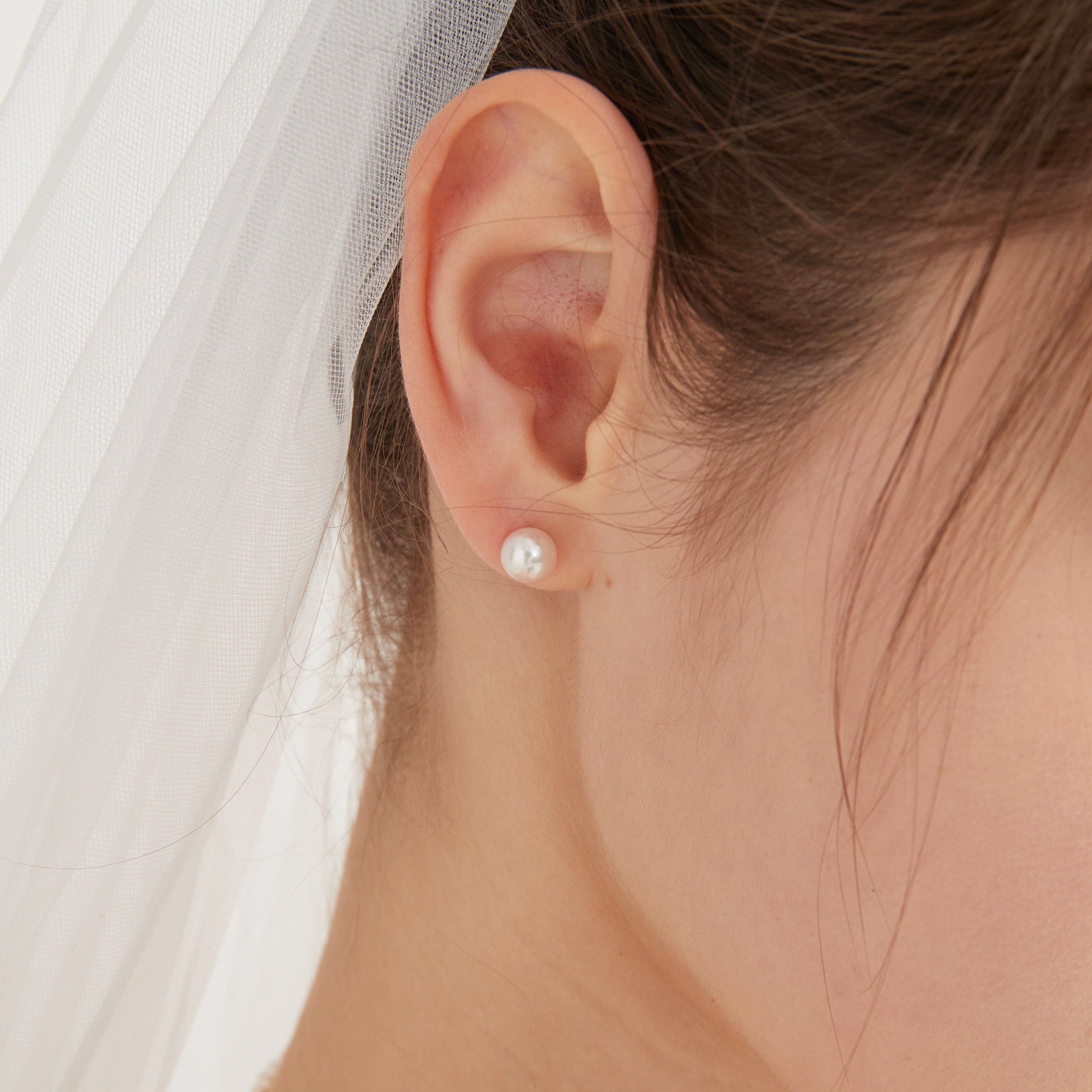 STMG Pearl Stud Earrings on ear