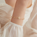 STMG Pearl Daisy Bracelet in gold on hand