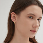 CZ Crystal Hoops in gold on ear