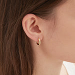 CZ Crystal Hoops in gold on ear