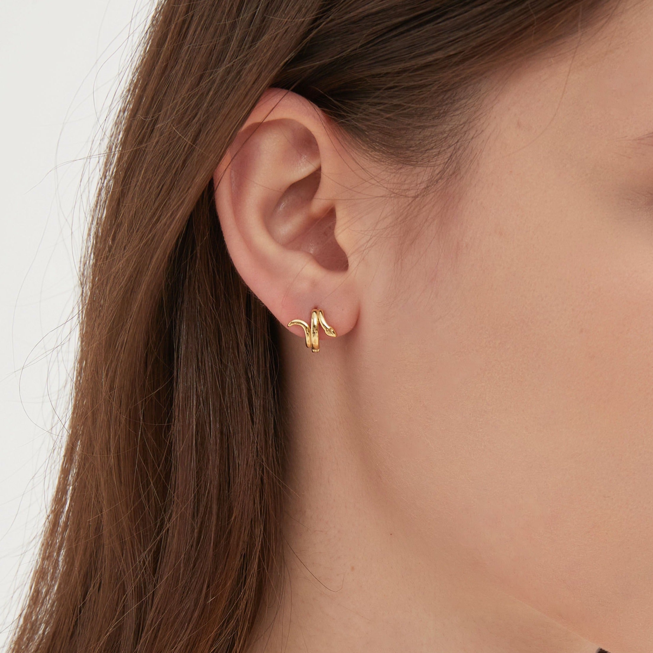 STMG Snake Hoops in gold on ear