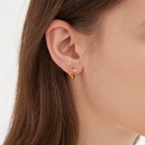 STMG Geometric Wave Hoops in gold on ear