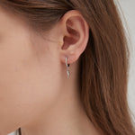 STMG Lightning Bolt Dangle Hoops in silver on ear