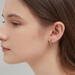 Geometric Star Hoops in silver on ear