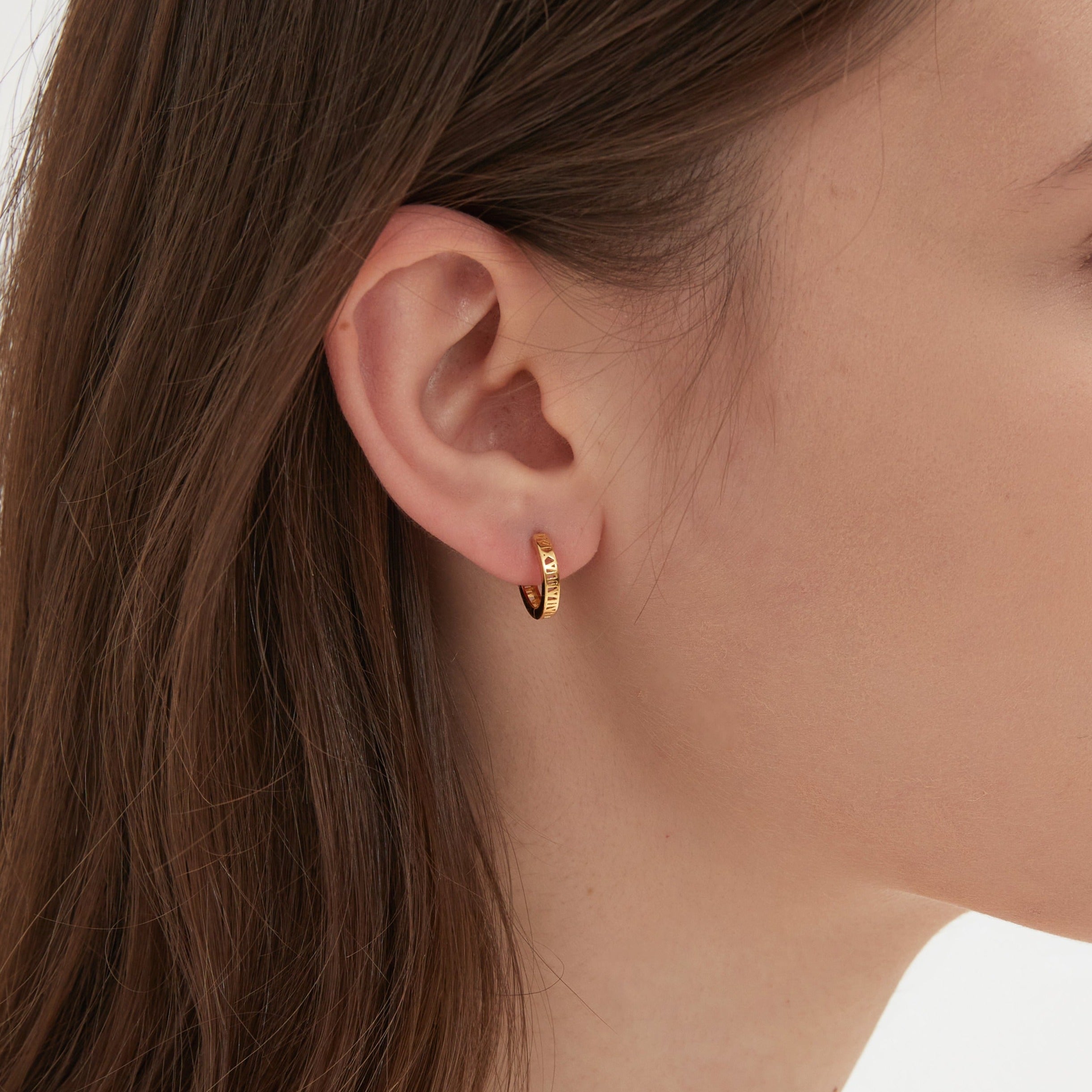 STMG Roman Numeral Hoops in gold on ear