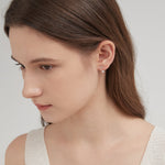 STMG Minimalist Diamond Stud Earrings in gold on ear