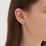 Bird and Feather Stud Earrings on ear