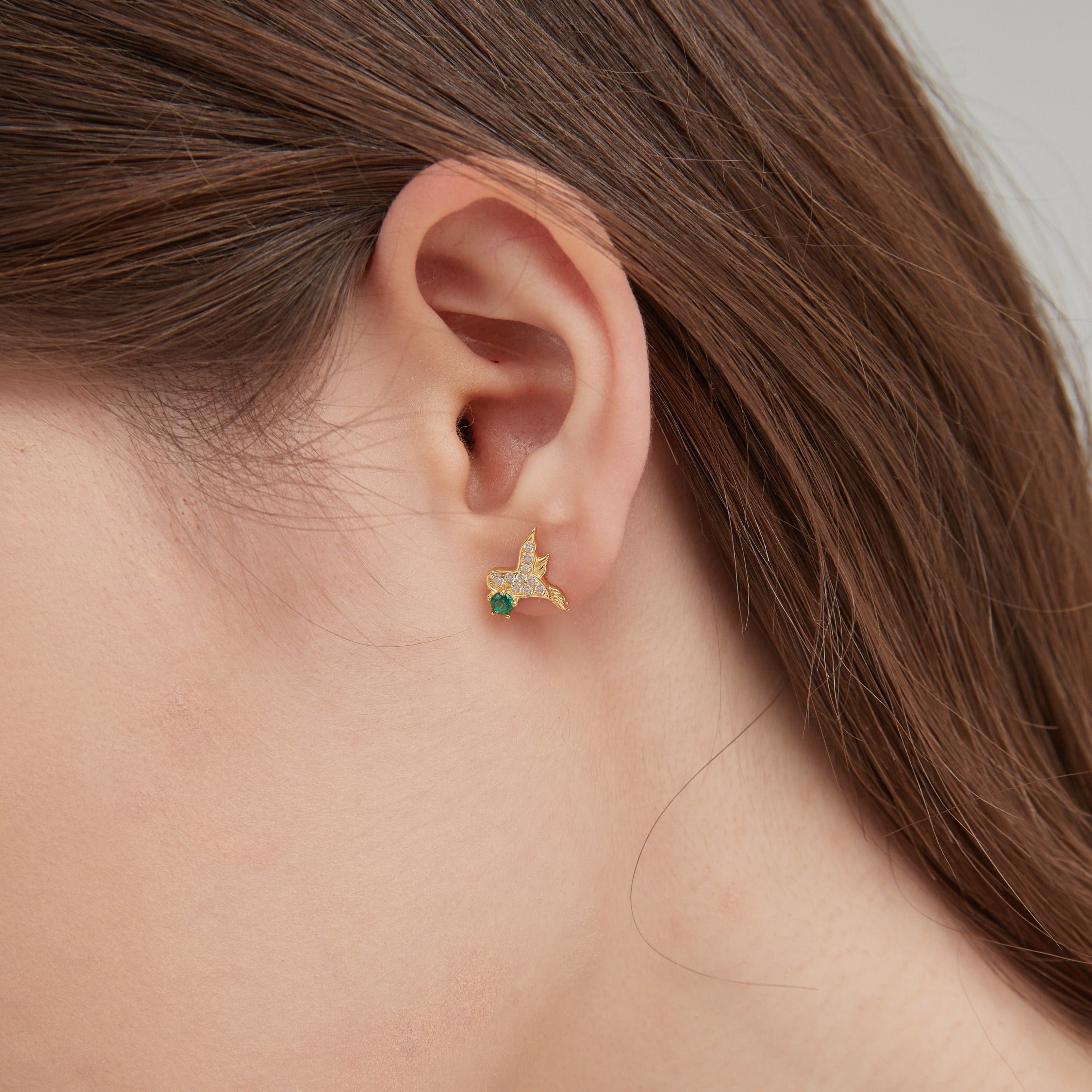 Bird and Feather Stud Earrings on ear