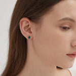 STMG Minimalist Emerald Earrings in silver on ear