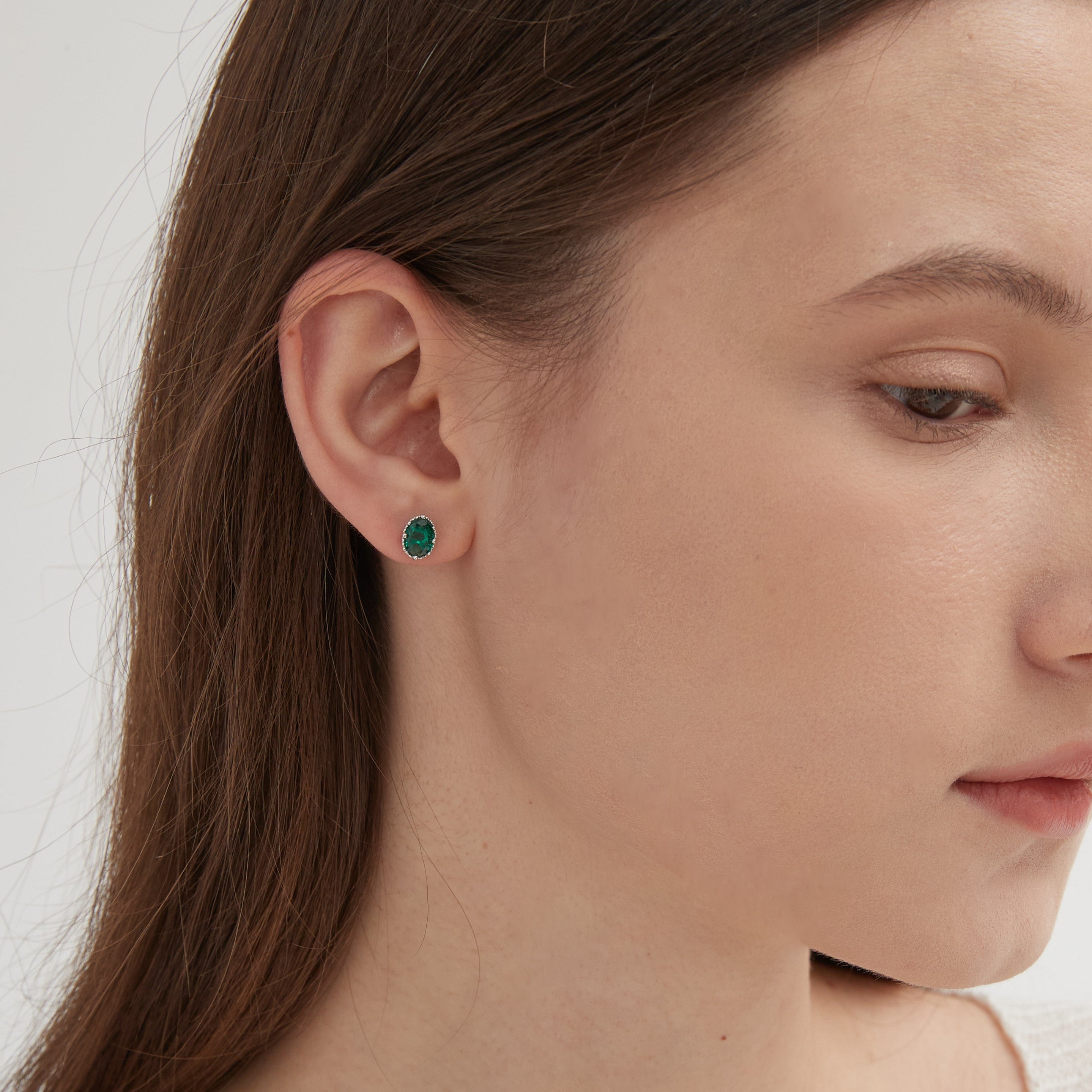 STMG Minimalist Emerald Earrings in silver on ear