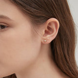 STMG Star Stud Earrings in gold on ear