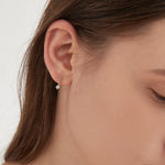 STMG Minimalist Hook Earrings in gold on ear