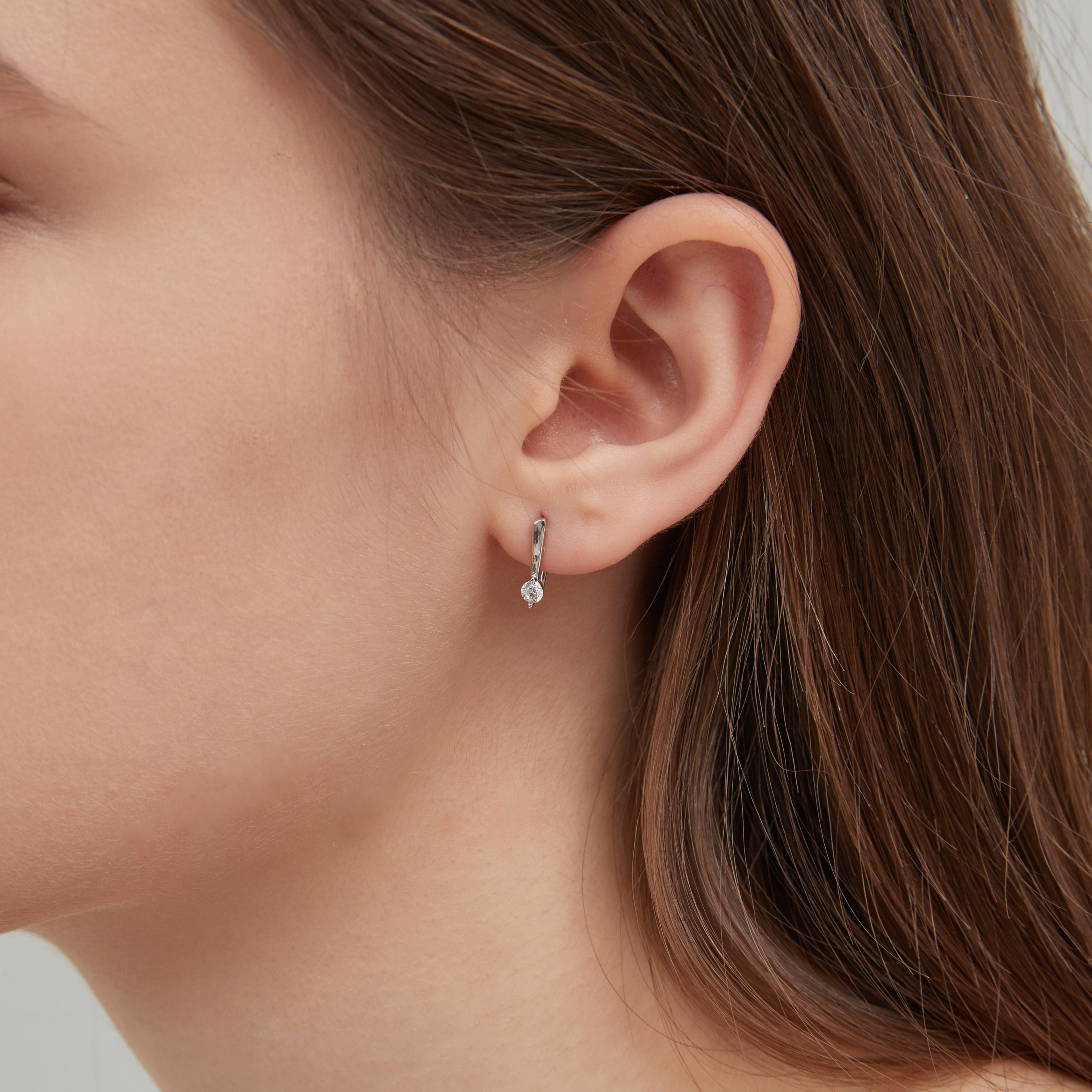 STMG Minimalist Hook Earrings in silver on ear