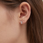 Emerald Cut Diamond Stud Earrings in silver on ear