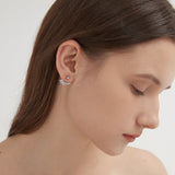 Angel Wing Stud Earrings in silver on ear