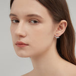 Angel Wing Stud Earrings in silver on ear