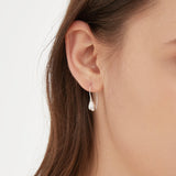 Flower Bud Hook Earrings in silver on ear