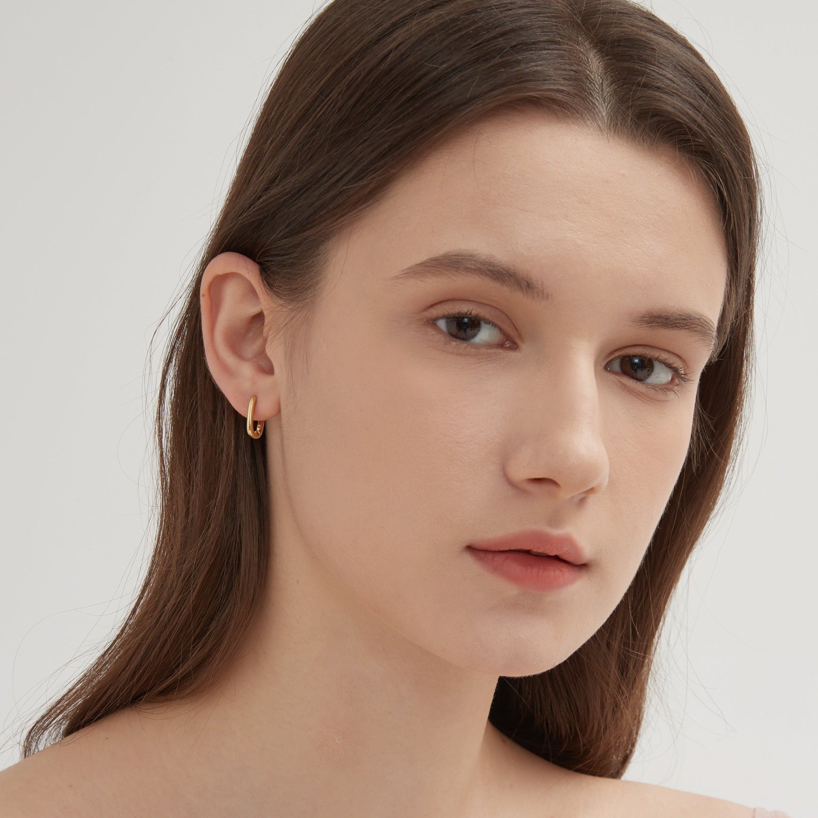 STMG Oval Rectangular Hoops in gold on ear