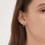 Droplet Hook Earrings in gold on ear