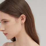 STMG Tiny Olive Leaf Hoops in silver on ear