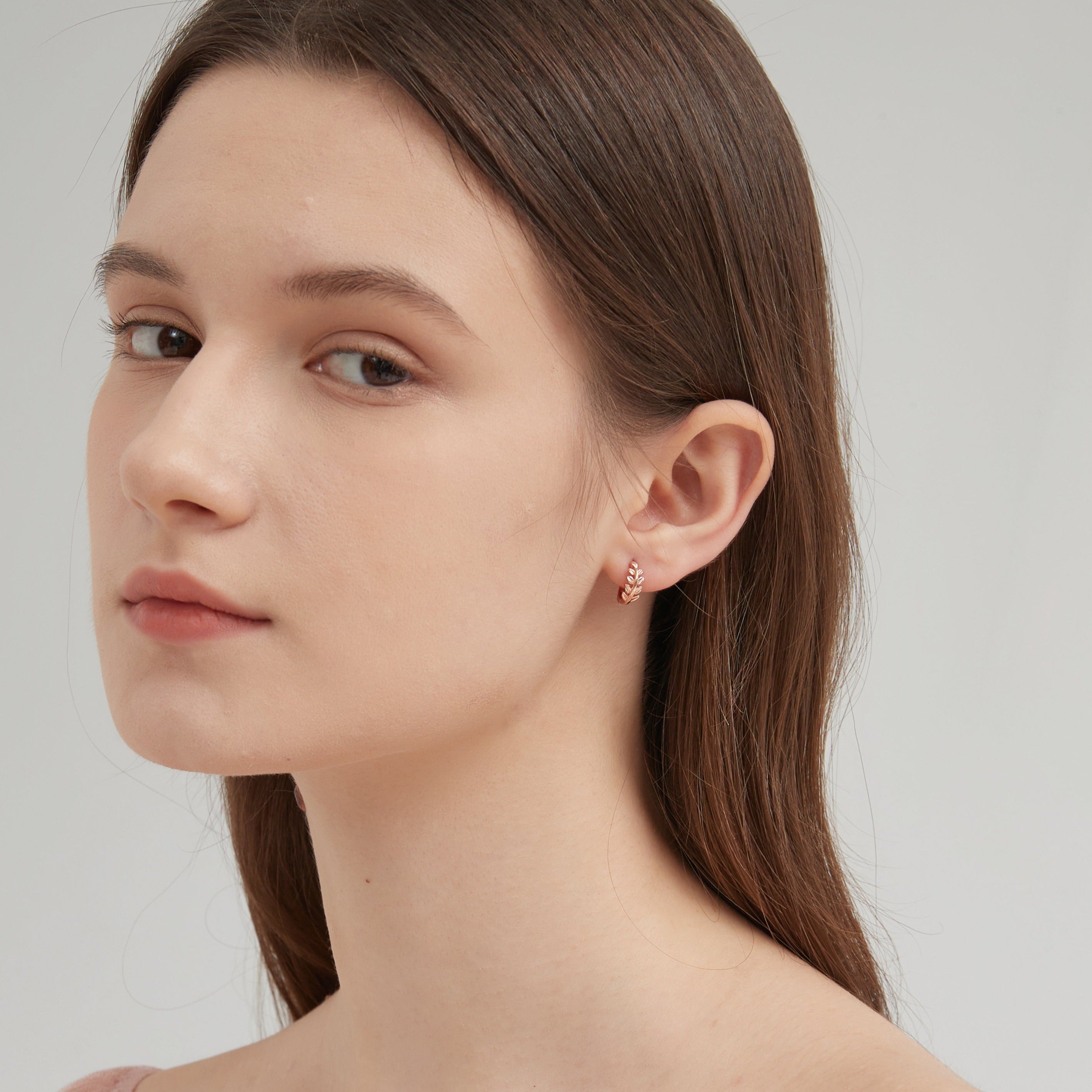 STMG Tiny Olive Leaf Hoops in rose gold on ear