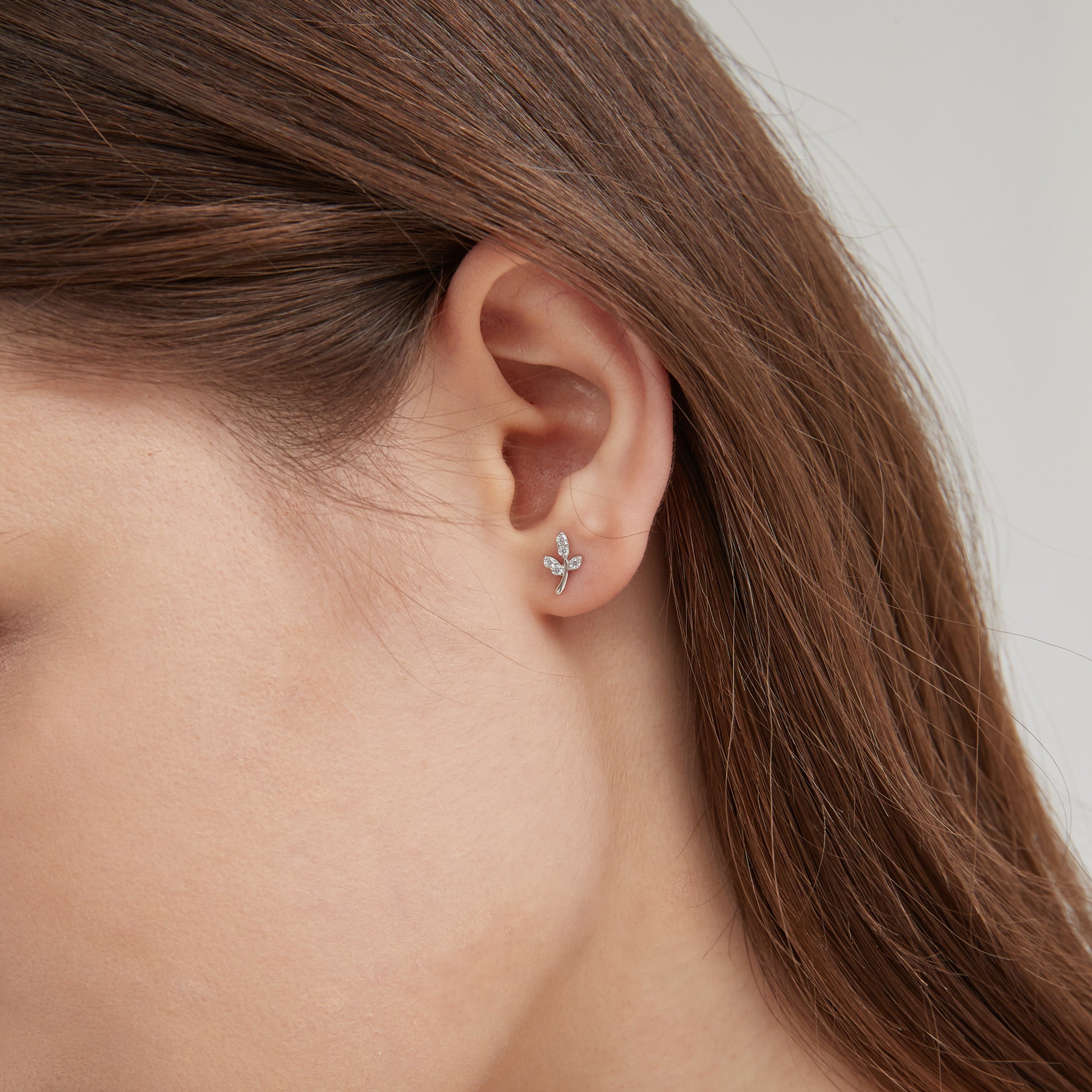 STMG Tiny Leaf Stud Earrings in silver on ear