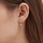 STMG Pear Cut  Diamond Dangle Earrings in silver on ear