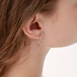 Geometric Cross Hoops in silver on ear