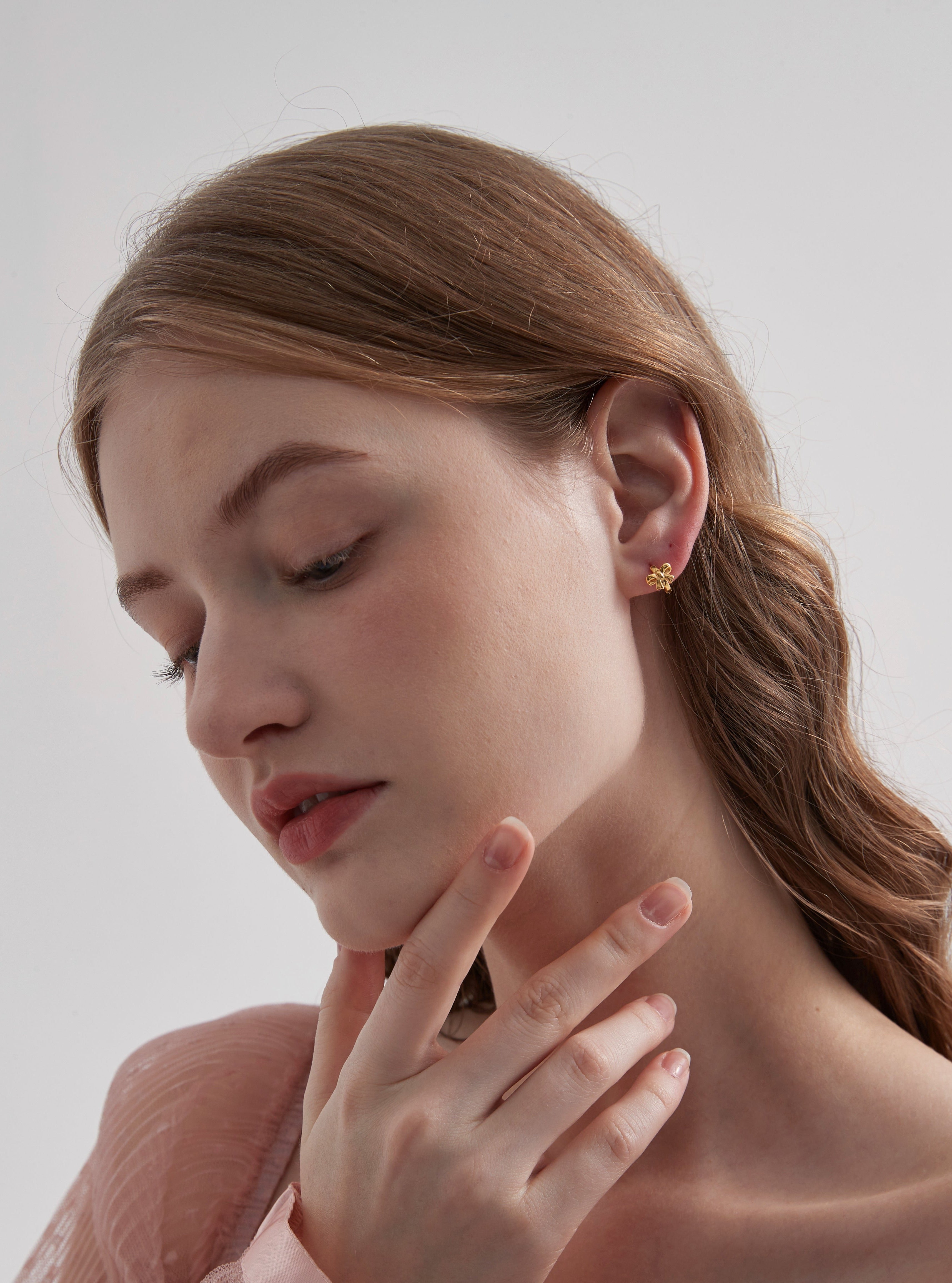 STMG Minimalist Bowknot Hoops in gold on ear