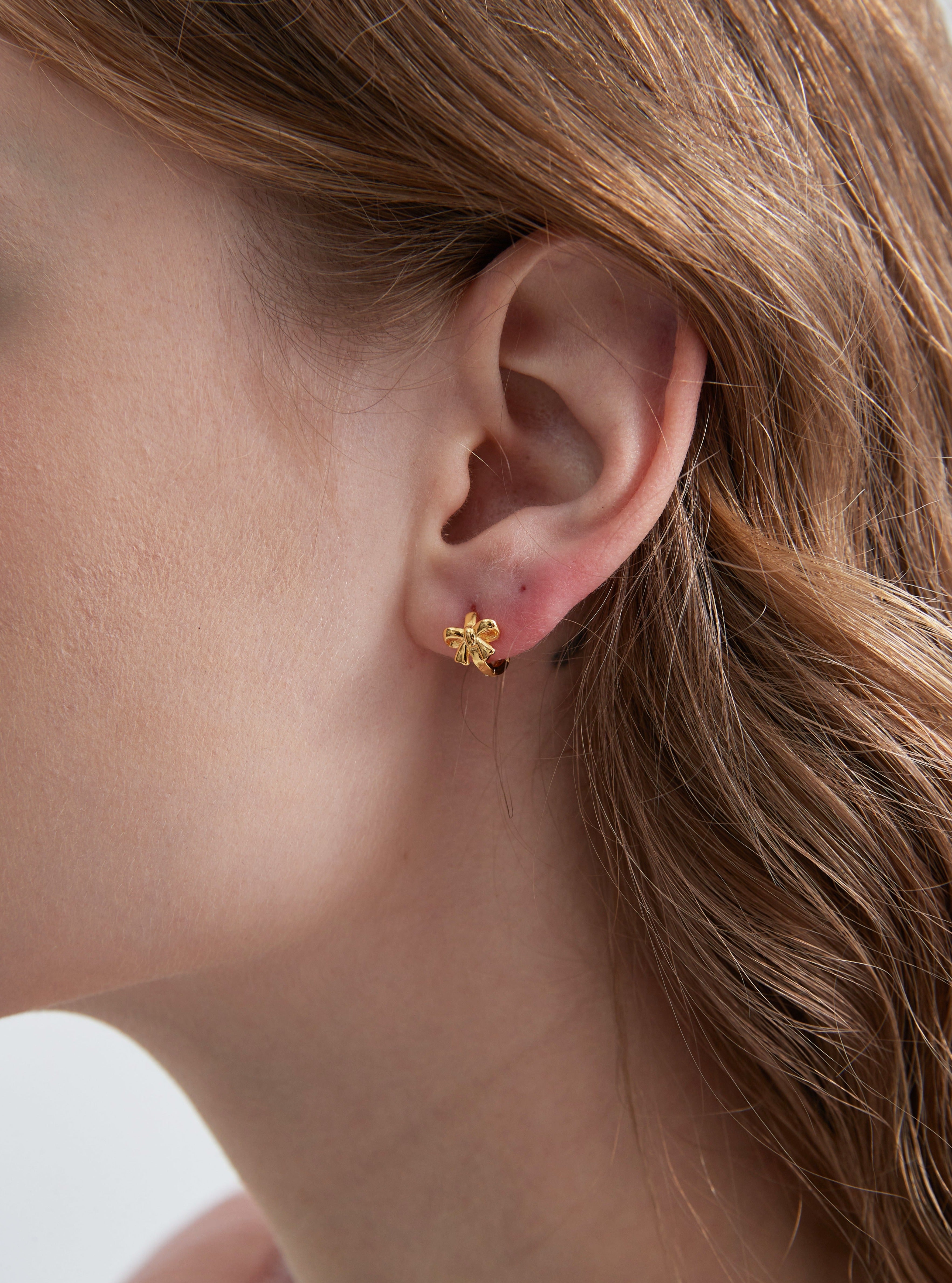 STMG Minimalist Bowknot Hoops in gold on ear