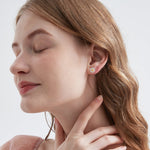 STMG Tiny Daisy Stud Earrings on ear