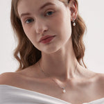 STMG Natural Pearl Knot Necklace in silver on neck with matching earrings on ear