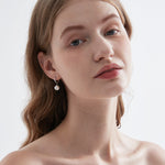 STMG Pearl Dangle Hoops in silver on ear