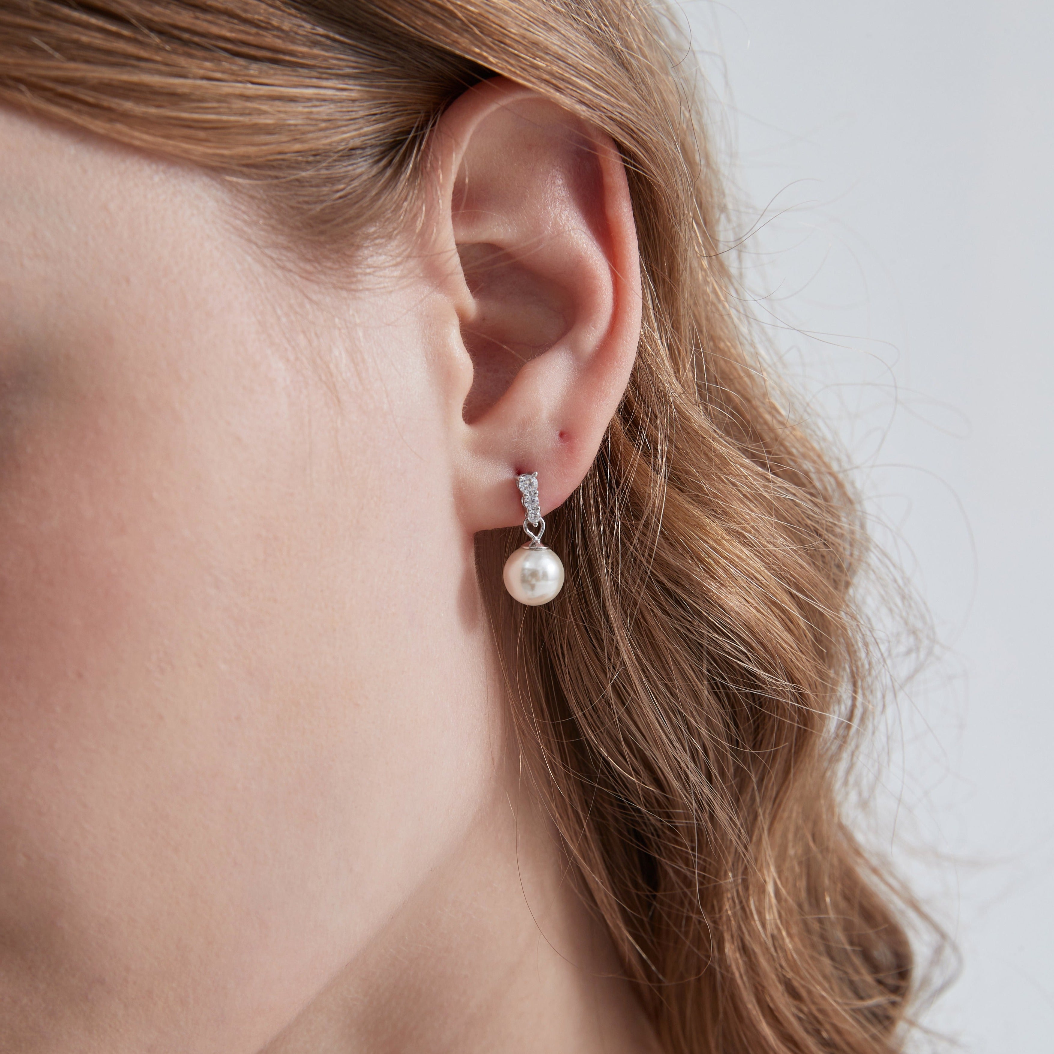 STMG Pearl Dangle Earrings in silver on ear