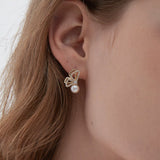 STMG Natural Pearl Butterfly Stud Earrings on ear