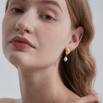 STMG Natural Pearl Dangle Earrings on ear