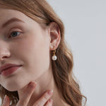 STMG Pearl Dangle Earrings on ear