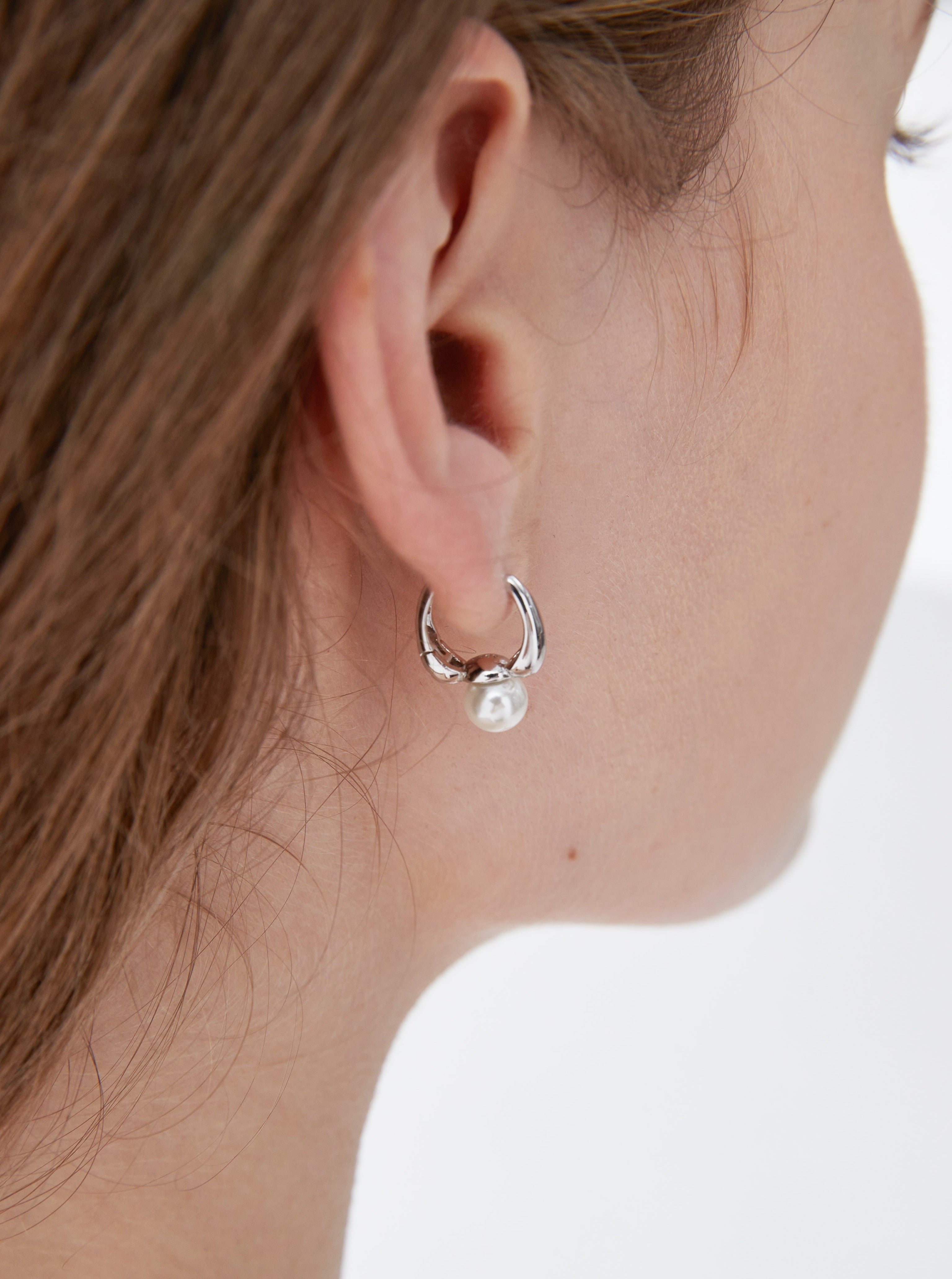 STMG Minimalist Pearl Hoops in silver on ear