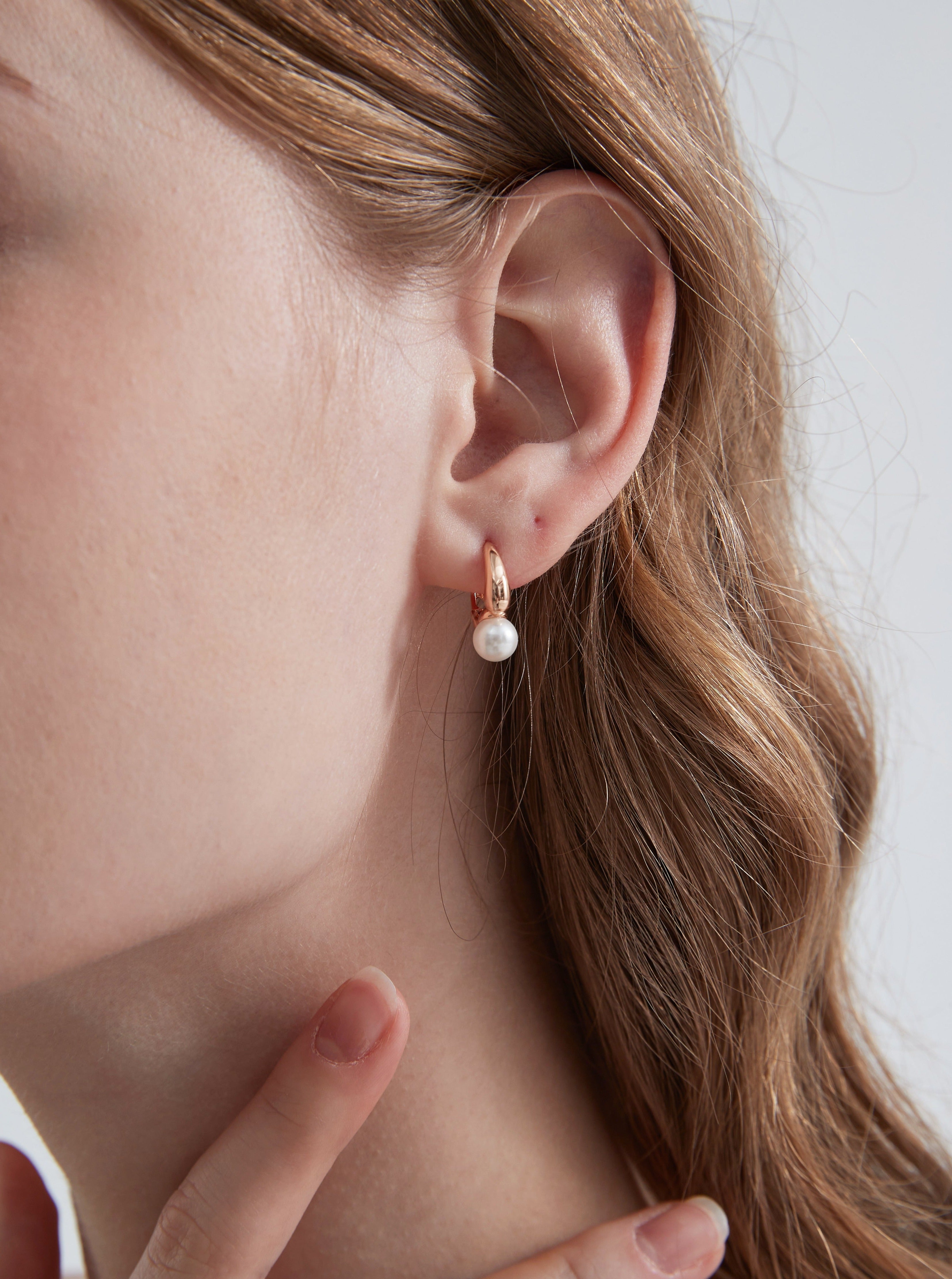 STMG Minimalist Pearl Hoops in champagne gold on ear