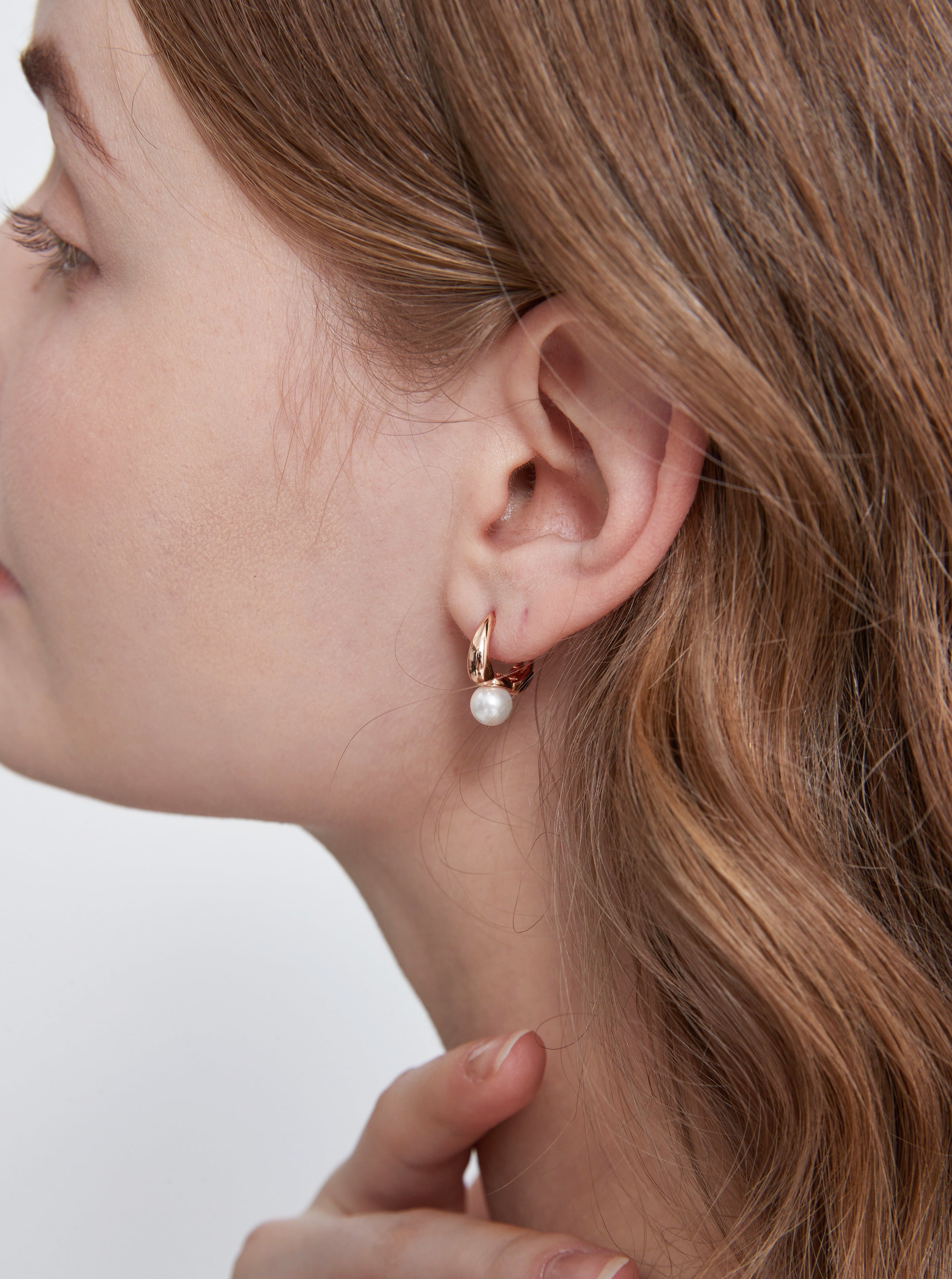 STMG Minimalist Pearl Hoops in champagne gold on ear