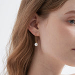 STMG Pearl Drop Dangle Earrings on ear