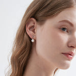 STMG Pearl Dangle Earrings in silver on ear