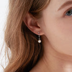 STMG Pearl Dangle Earrings in silver on ear